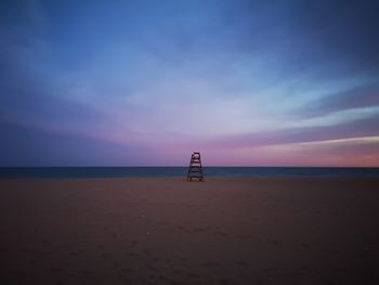 Scenic view of beach against sky during sunset