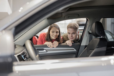 Portrait of young woman in car