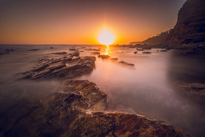 Scenic view of sea against sky at sunset