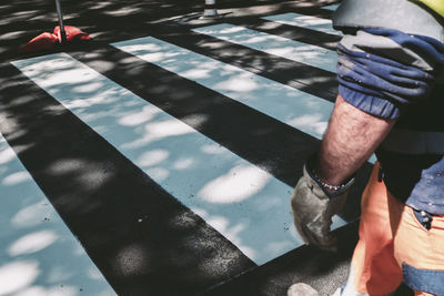 Low section of man walking on road