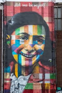 Portrait of man with multi colored glass window