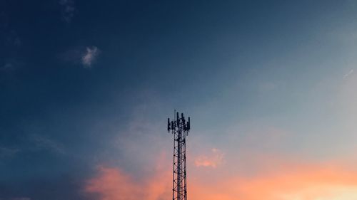 Low angle view of communications tower against sky during sunset
