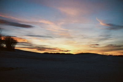 Scenic view of beach against sky during sunset