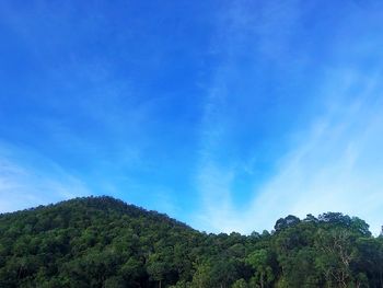 Low angle view of mountain against blue sky