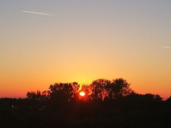 Silhouette trees against sky during sunset