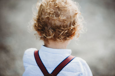 Rear view of boy standing outdoors