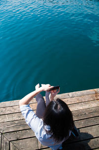 Low section of young woman in water