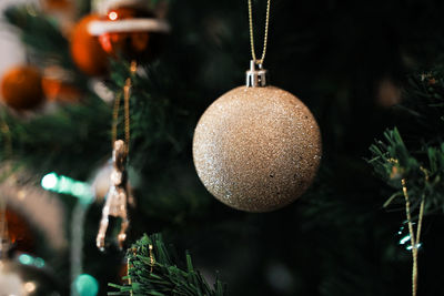 Close-up of christmas decorations hanging on tree