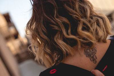 Close-up of woman with tattoo on back