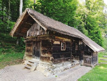 Old house amidst trees and building