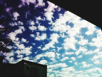 Low angle view of building against cloudy sky