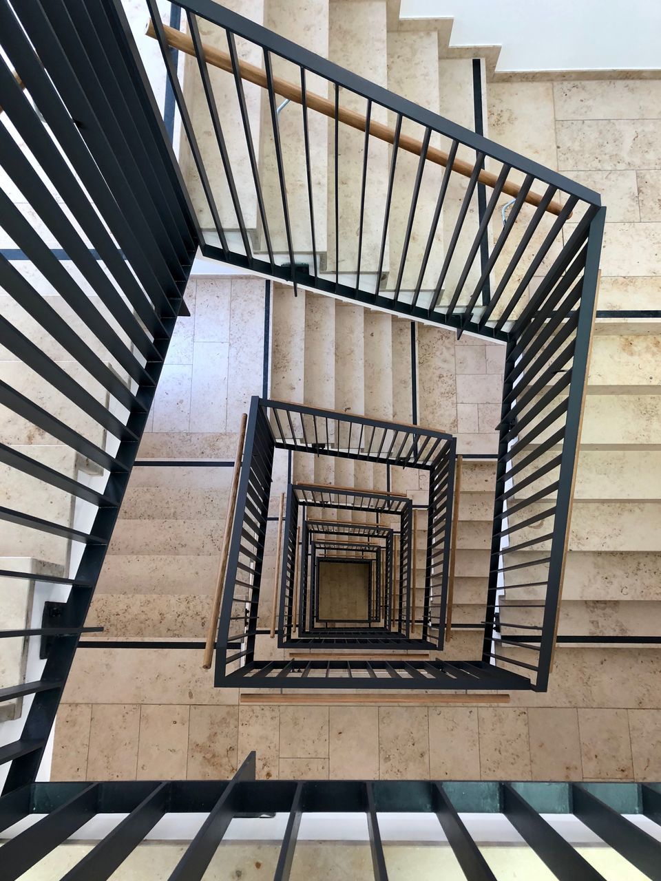 staircase, steps and staircases, railing, architecture, built structure, spiral, no people, spiral staircase, pattern, day, indoors, high angle view, building, design, directly above, empty, absence, wood - material, diminishing perspective, directly below