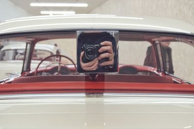 Portrait of man photographing car