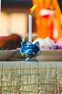 Close-up of burning candles on table