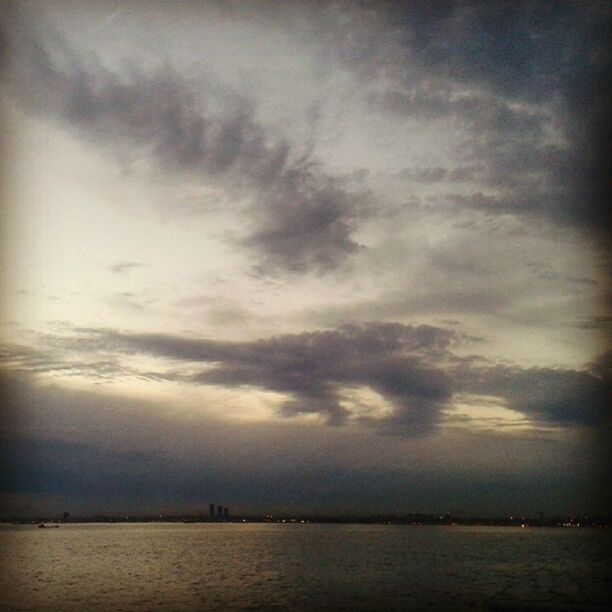 water, sea, sky, waterfront, cloud - sky, scenics, tranquility, tranquil scene, cloudy, beauty in nature, nature, horizon over water, cloud, sunset, weather, idyllic, silhouette, outdoors, dusk, rippled