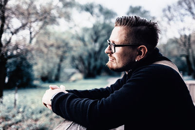 Side view of man wearing eyeglasses in park