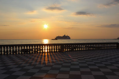 Royal carribean cruise in the port of livorno passes in front of the mascagni terrace at sunset