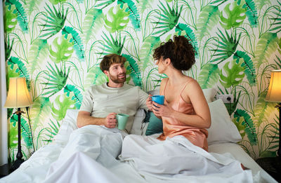 Young couple sitting on bed