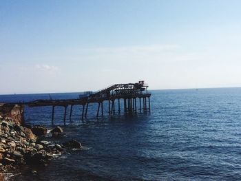 Pier over sea against sky