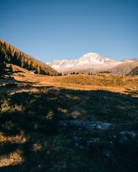 Scenic view of mountains against clear blue sky