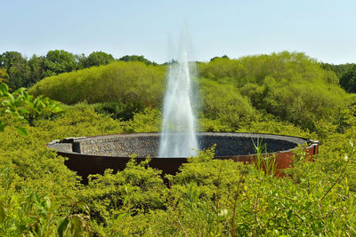 Scenic view of artifical geyser against sky