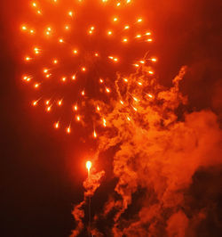 Low angle view of firework display at night