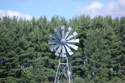 High section view of windmill against trees