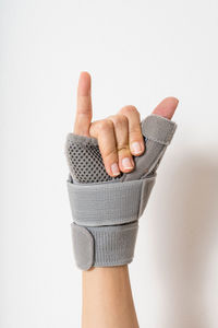 Close-up of human hand against white background