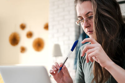 Work from home. middle aged brunette woman with glasses works at home online.