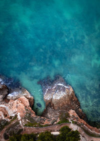 High angle view of rocks in sea