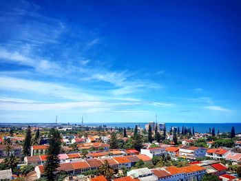 High angle view of cityscape against blue sky