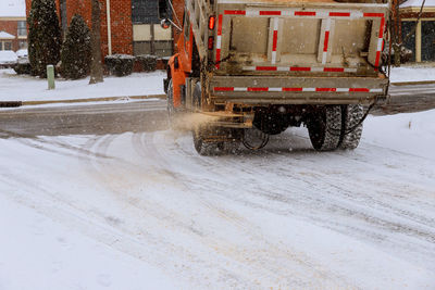 Snow covered road in city