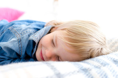 Portrait of cute baby lying down on bed