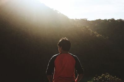 Rear view of man standing against sky