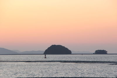 Scenic view of sea against orange sky