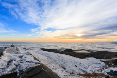 Scenic view of snowcapped mountains against sky during sunset