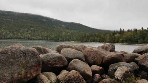 Scenic view of rocks in lake against sky