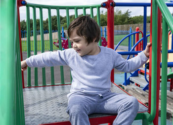 Boy playing on slide at playground