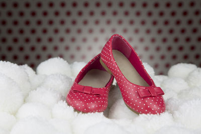 Close-up of pink shoes on white fabric