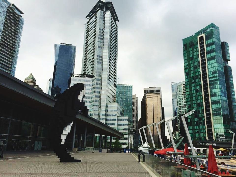 LOW ANGLE VIEW OF OFFICE BUILDINGS AGAINST SKY