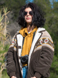 Portrait of woman wearing sunglasses while standing outdoors