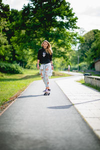 Woman riding bicycle on footpath