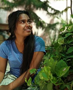 Portrait of a smiling young woman looking away