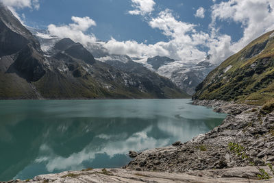 Scenic view of lake and mountains against sky