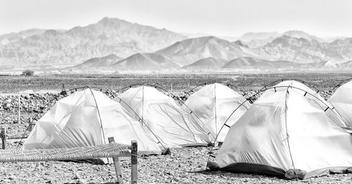 Tent on beach against mountain range