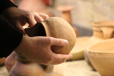 Close-up of hands holding earthen pot