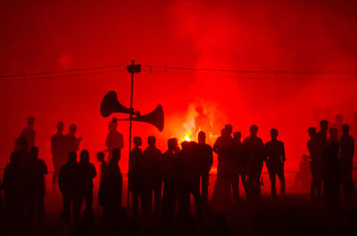 Silhouette of people at night