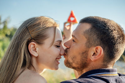 Young happy loving couple kissing and having fun together outdoors. young couple in love on summer