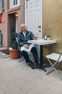 Portrait of a smiling young man sitting on chair