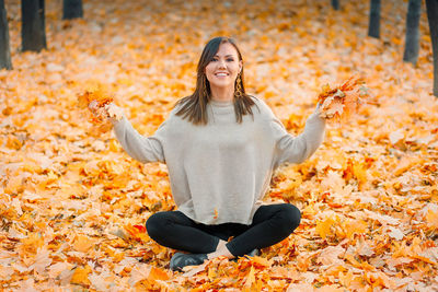 Portrait of woman standing against yellow flower